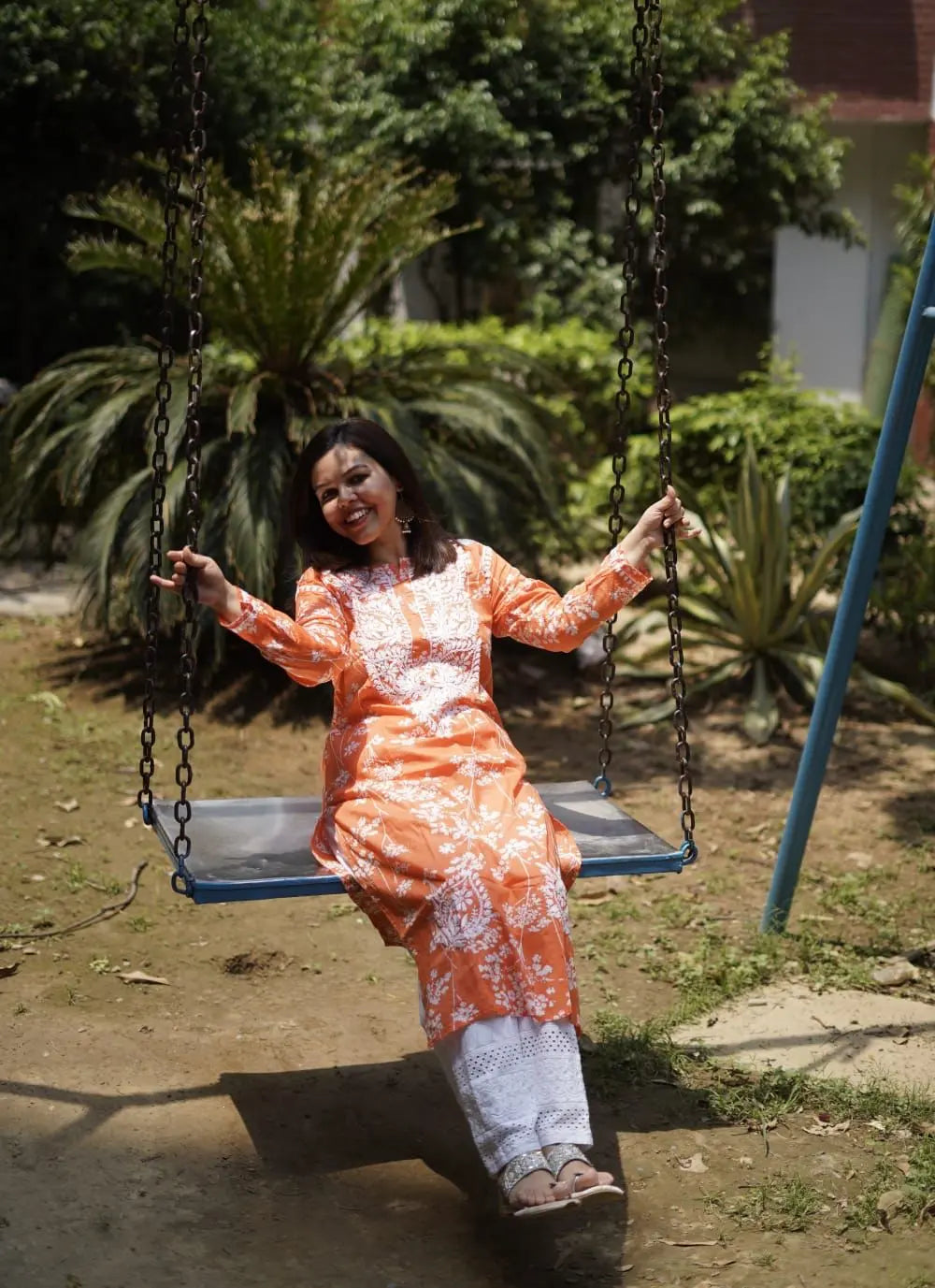 Batool orange mul mul chikankari kurta featuring delicate hand embroidery and soft breathable fabric for vibrant everyday ethnic wear by Hayat's Lucknowi.