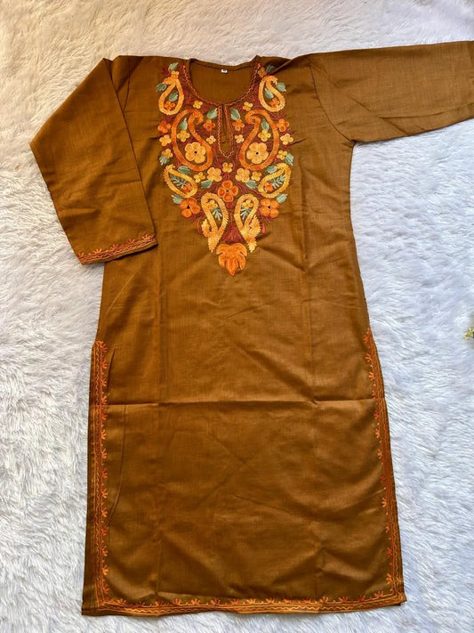 Brown dress with intricate orange and green embroidery on a white background