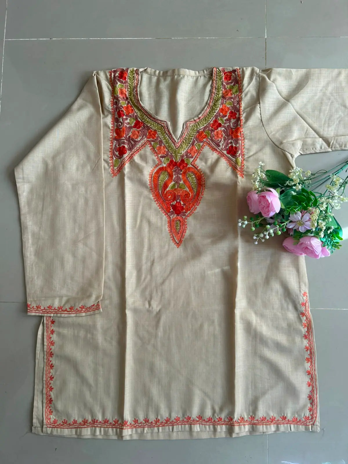 
Aaira soft beige cotton Kashmiri short embroidered kurti featuring intricate traditional Kashmiri embroidery and soft breathable cotton fabric for elegant everyday ethnic wear by Hayat's Lucknowi.
