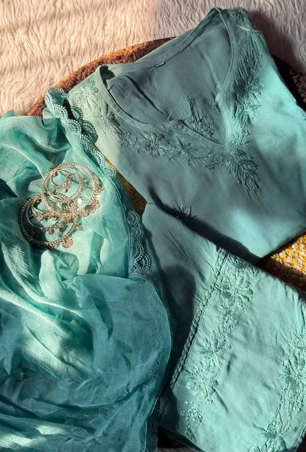 Aqua green sleeveless rayon Chikankari Farshi set featuring intricate handcrafted Chikankari embroidery on soft, flowy rayon fabric with a graceful traditional Farshi silhouette for elegant festive and ethnic wear by Hayat's Lucknowi.
