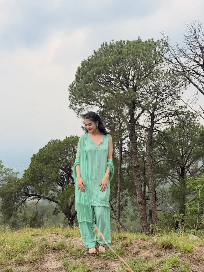 Aqua green sleeveless rayon Chikankari Farshi set featuring intricate handcrafted Chikankari embroidery on soft, flowy rayon fabric with a graceful traditional Farshi silhouette for elegant festive and ethnic wear by Hayat's Lucknowi.
