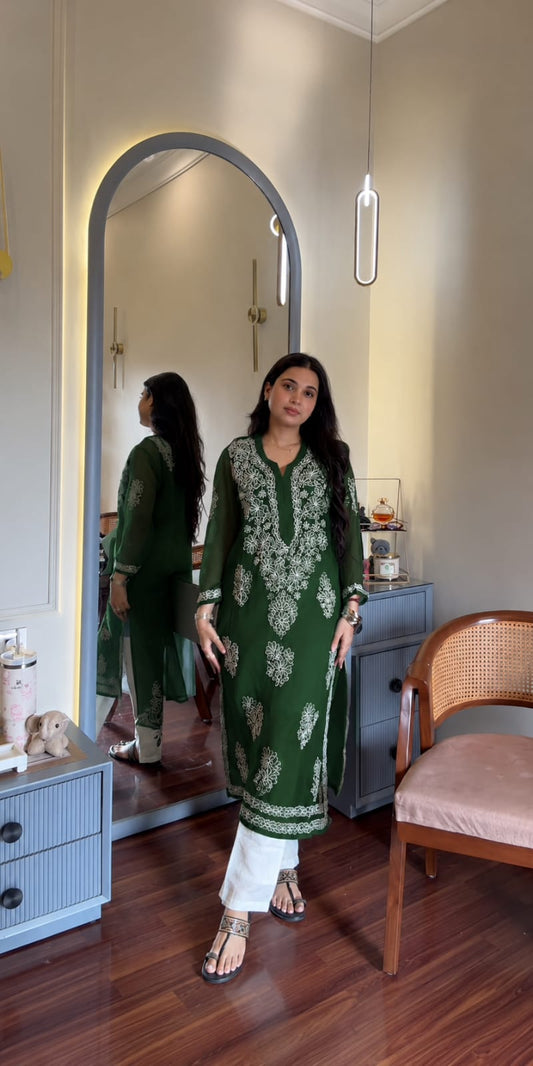 

Ayena Bottle Green Georgette Chikankari Kurti featuring intricate hand embroidery on lightweight georgette fabric for an elegant festive and ethnic look by Hayat’s Lucknowi.
