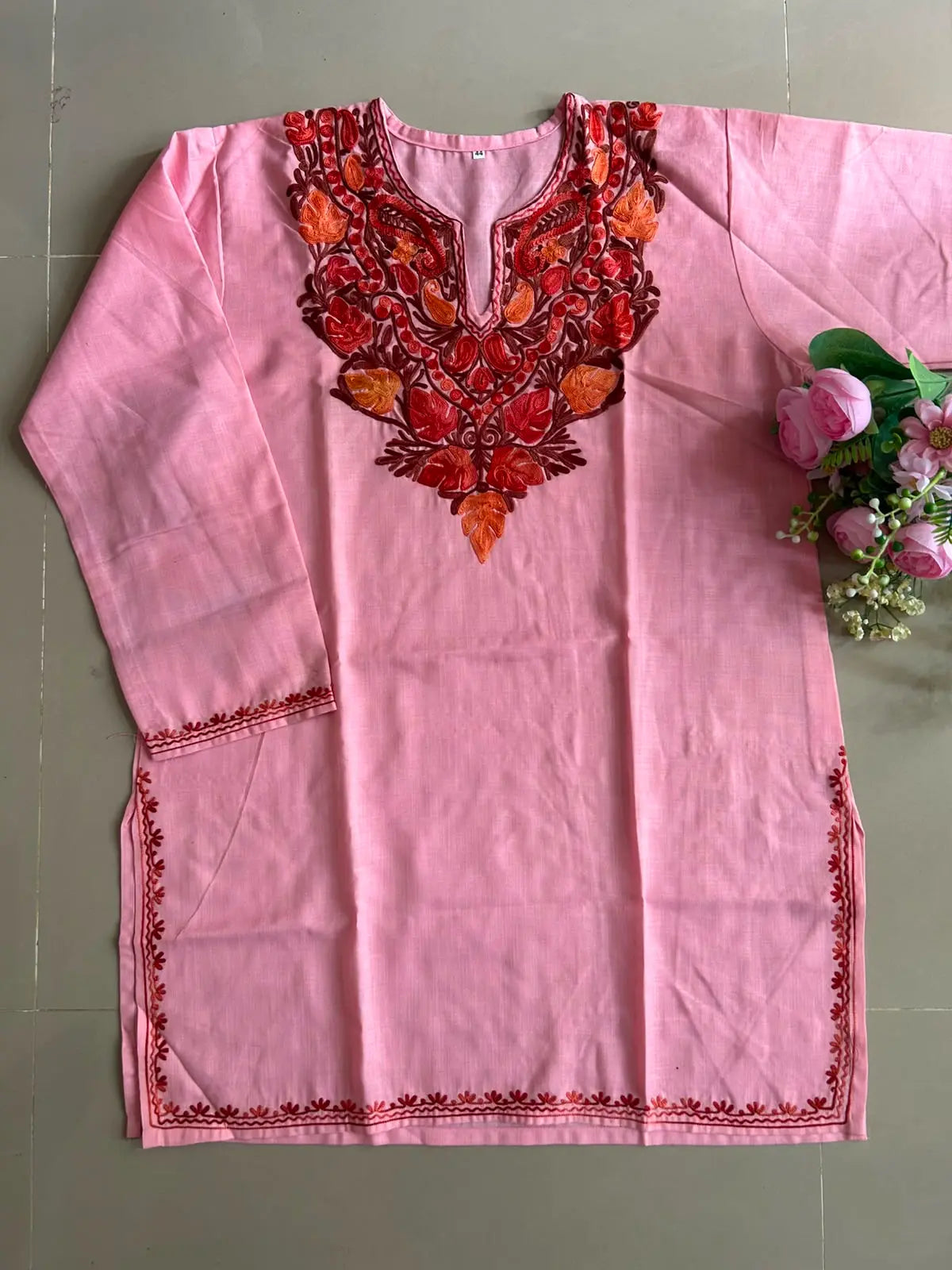 
Baby pink cotton Kashmiri short embroidered kurti featuring intricate traditional Kashmiri embroidery and soft breathable cotton fabric for delicate and elegant everyday ethnic wear by Hayat's Lucknowi.
