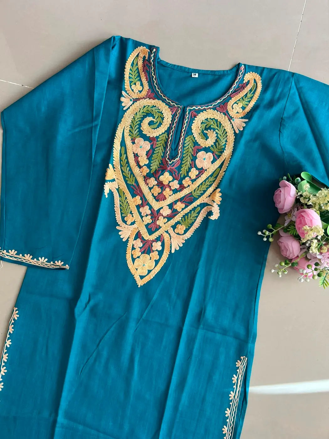 
Frozi blue cotton Kashmiri mid-length embroidered kurta featuring intricate traditional Kashmiri embroidery and soft breathable cotton fabric for elegant everyday ethnic wear by Hayat's Lucknowi.
