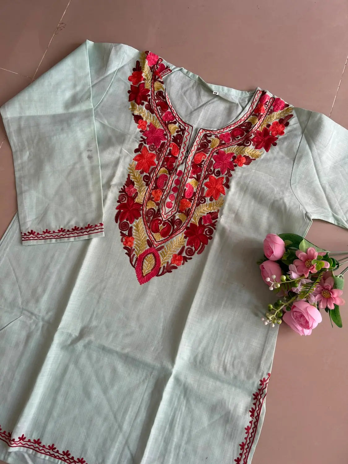 
Mint-pista cotton Kashmiri short embroidered kurti featuring intricate traditional Kashmiri embroidery and soft breathable cotton fabric for fresh and elegant everyday ethnic wear by Hayat's Lucknowi.
