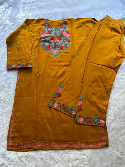 
Mustard Kashmiri woolen pheran co-ord set crafted for traditional winter styling by Hayat's Lucknowi
