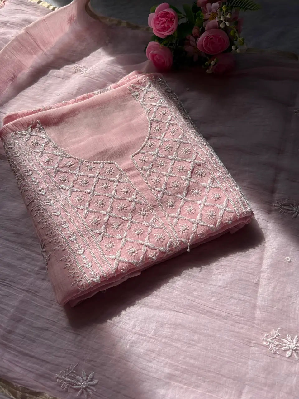 
Naaz women's pink mul Chanderi handwork kurta and dupatta unstitched suit featuring intricate handcrafted detailing and elegant traditional styling for festive ethnic wear by Hayat's Lucknowi
