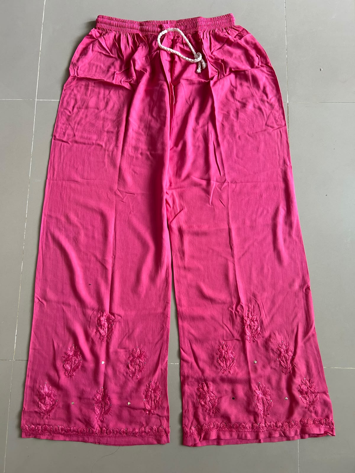 
Nagma hot pink rayon Lucknowi Mukesh chikankari set with dupatta featuring intricate hand embroidery and shimmering Mukesh work for vibrant festive and ethnic wear by Hayat's Lucknowi.
