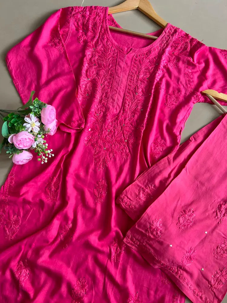 
Nagma hot pink rayon Lucknowi Mukesh chikankari set with dupatta featuring intricate hand embroidery and shimmering Mukesh work for vibrant festive and ethnic wear by Hayat's Lucknowi.

