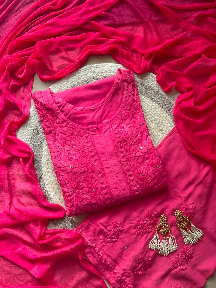 
Nagma hot pink rayon Lucknowi Mukesh chikankari set with dupatta featuring intricate hand embroidery and shimmering Mukesh work for vibrant festive and ethnic wear by Hayat's Lucknowi.
