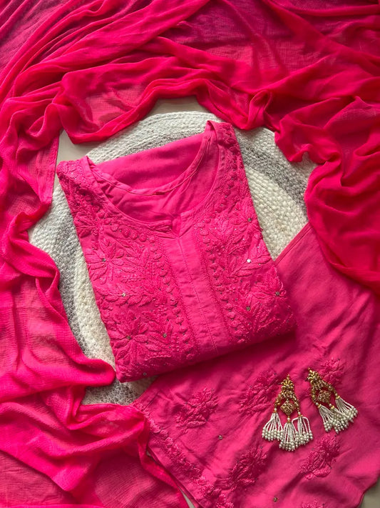
Nagma hot pink rayon Lucknowi Mukesh chikankari set with dupatta featuring intricate hand embroidery and shimmering Mukesh work for vibrant festive and ethnic wear by Hayat's Lucknowi.
