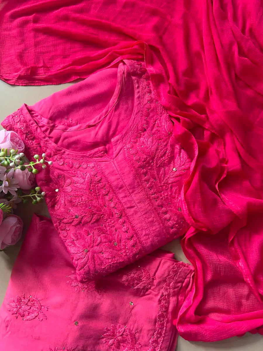 
Nagma hot pink rayon Lucknowi Mukesh chikankari set with dupatta featuring intricate hand embroidery and shimmering Mukesh work for vibrant festive and ethnic wear by Hayat's Lucknowi.
