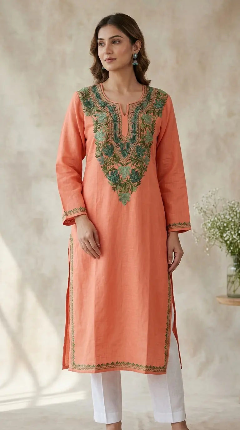 
Peach Kashmiri long kurta with green chinar embroidery featuring intricate traditional Kashmiri craftsmanship and elegant heritage-inspired detailing for timeless ethnic wear by Hayat's Lucknowi
