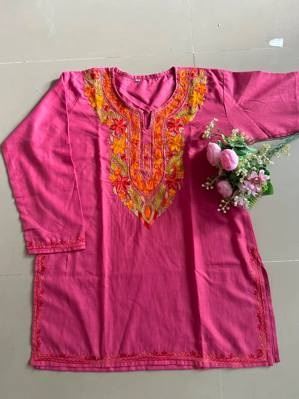Rani pink cotton Kashmiri short embroidered kurti featuring intricate traditional Kashmiri embroidery and soft breathable cotton fabric for stylish everyday ethnic wear by Hayat's Lucknowi.
