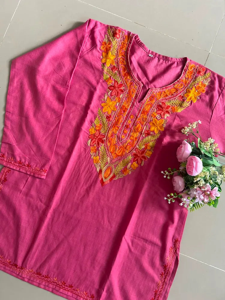 
Rani pink cotton Kashmiri short embroidered kurti featuring intricate traditional Kashmiri embroidery and soft breathable cotton fabric for stylish everyday ethnic wear by Hayat's Lucknowi.
