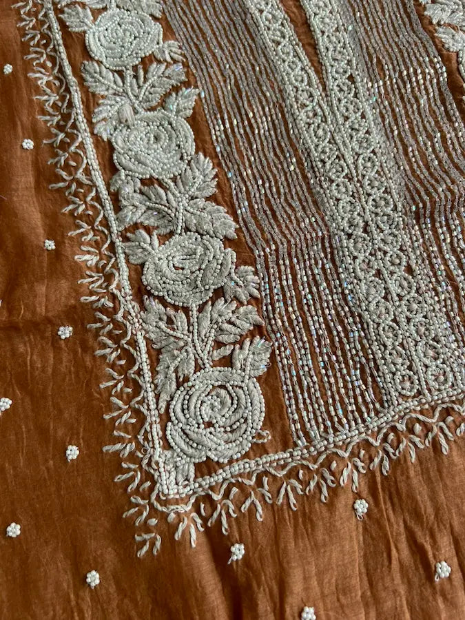 
Reshmi women's brown mul Chanderi handwork kurta and dupatta unstitched suit featuring intricate handcrafted detailing and elegant traditional craftsmanship for timeless ethnic wear by Hayat's Lucknowi.
