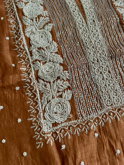 
Reshmi women's brown mul Chanderi handwork kurta and dupatta unstitched suit featuring intricate handcrafted detailing and elegant traditional craftsmanship for timeless ethnic wear by Hayat's Lucknowi.
