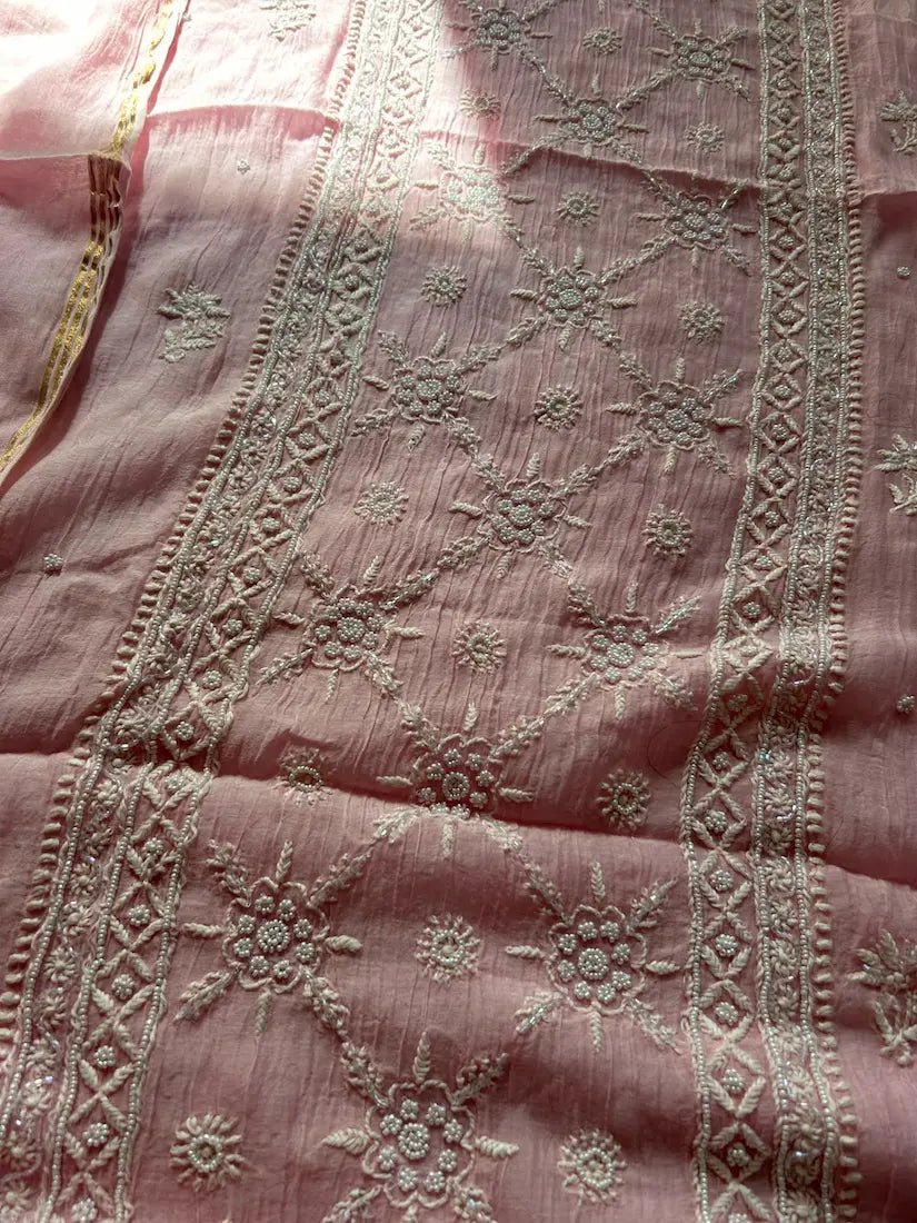 
Roohi women's pink mul Chanderi handwork kurta and dupatta unstitched suit featuring intricate handcrafted detailing and elegant traditional craftsmanship for graceful ethnic wear by Hayat's Lucknowi.
