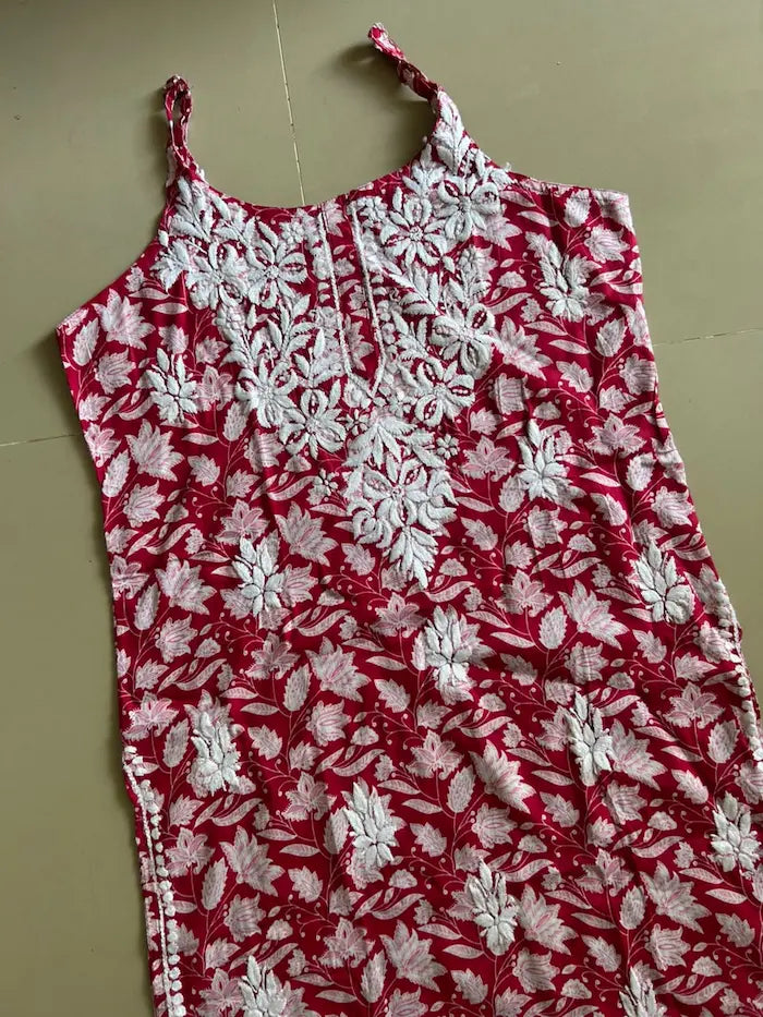 Saaz Red Noodle Strap Mul Mul Kurta featuring delicate Chikankari embroidery on lightweight, soft and breathable Mul Mul cotton fabric for an elegant and effortless ethnic look by Hayat’s Lucknowi.

