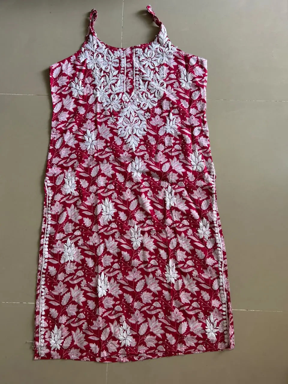 Saaz Red Noodle Strap Mul Mul Kurta featuring delicate Chikankari embroidery on lightweight, soft and breathable Mul Mul cotton fabric for an elegant and effortless ethnic look by Hayat’s Lucknowi.
