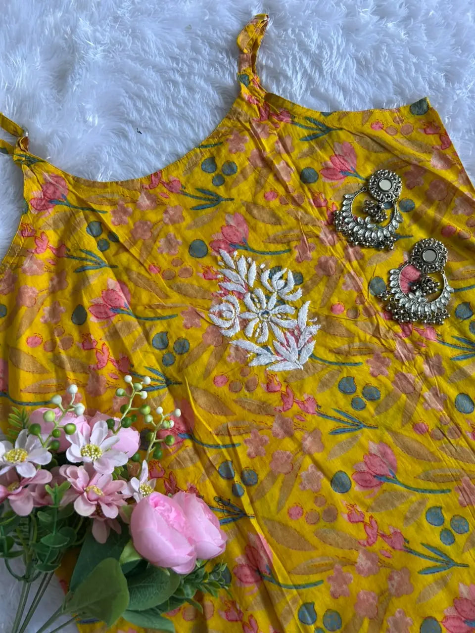 Saaz Yellow Noodle Strap Mul Mul Kurta featuring delicate Chikankari embroidery on lightweight, soft and breathable Mul Mul cotton fabric for an elegant and effortless ethnic look by Hayat’s Lucknowi.
