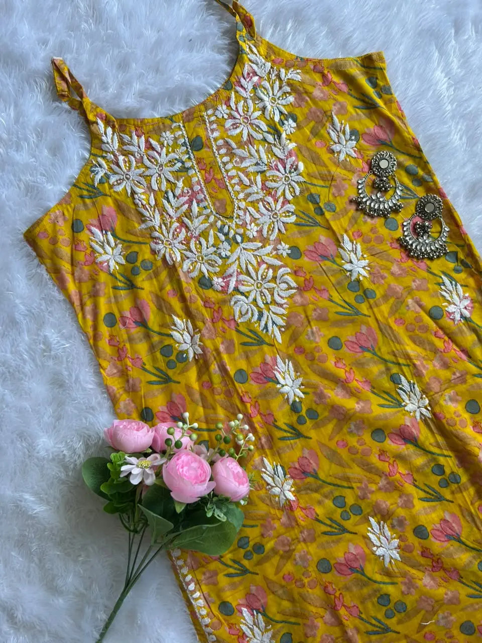 Saaz Yellow Noodle Strap Mul Mul Kurta featuring delicate Chikankari embroidery on lightweight, soft and breathable Mul Mul cotton fabric for an elegant and effortless ethnic look by Hayat’s Lucknowi.
