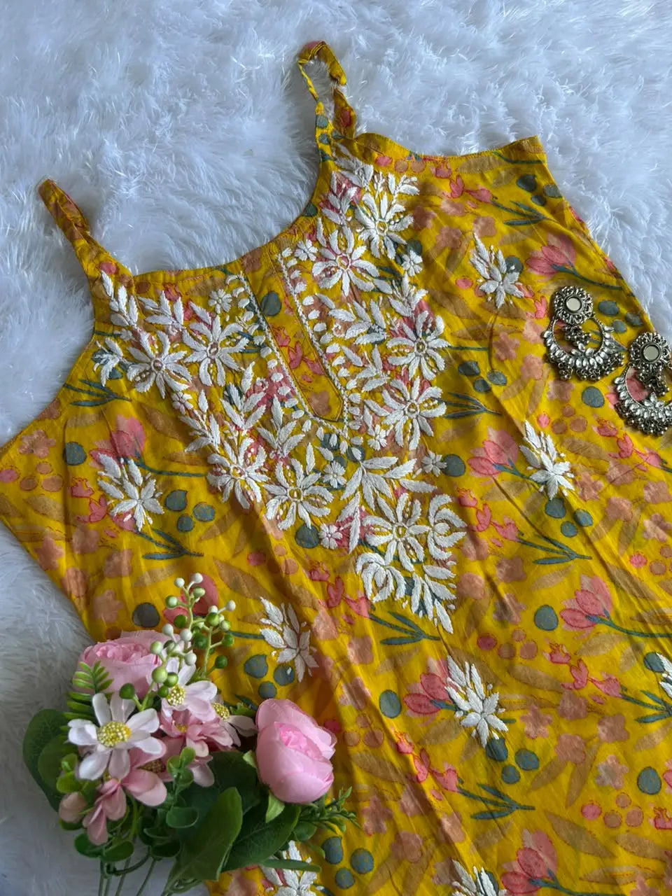 Saaz Yellow Noodle Strap Mul Mul Kurta featuring delicate Chikankari embroidery on lightweight, soft and breathable Mul Mul cotton fabric for an elegant and effortless ethnic look by Hayat’s Lucknowi.
