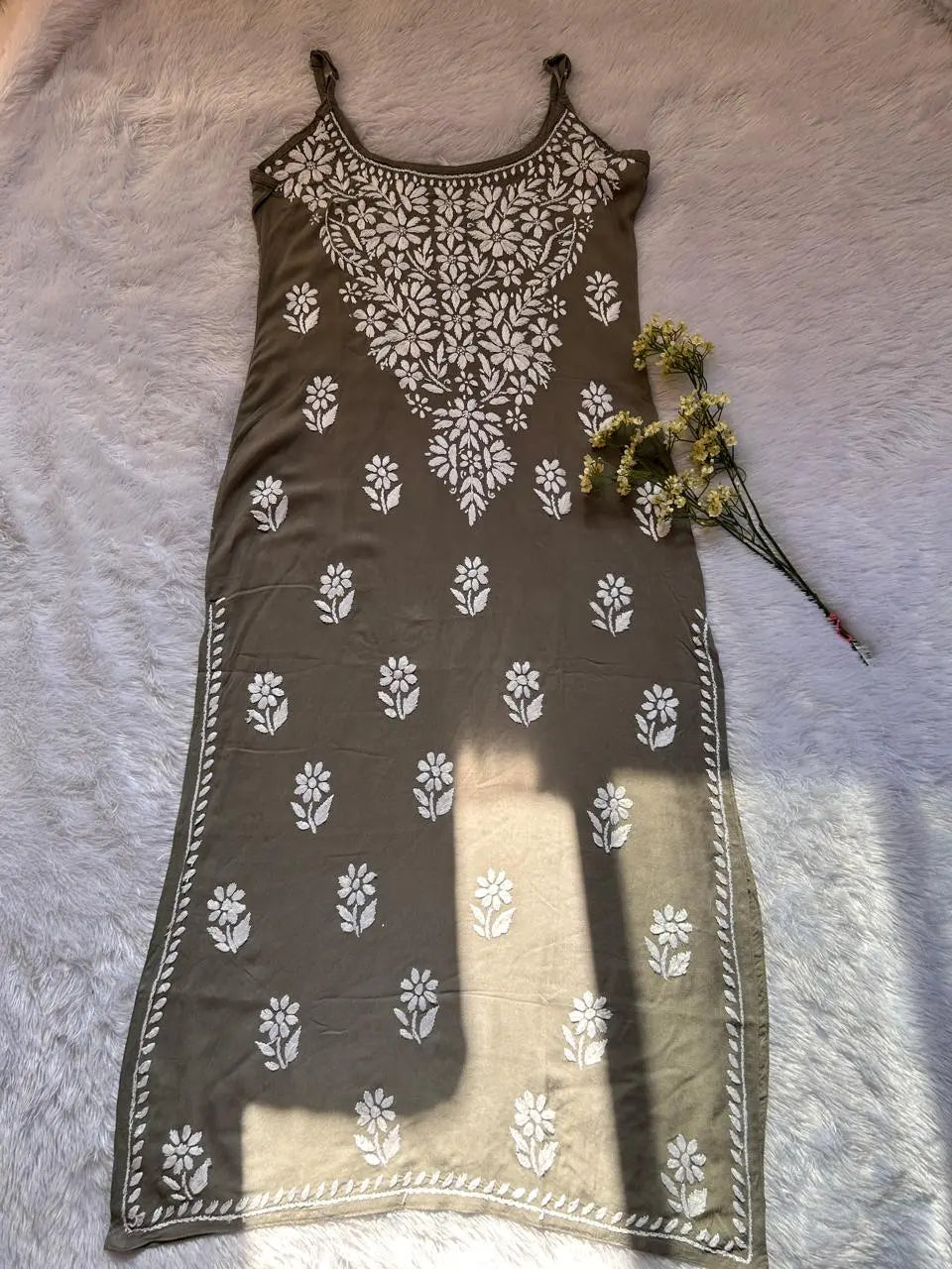 
Saba gray noodle strap chikankari long kurti featuring delicate hand embroidery and lightweight breathable fabric for elegant contemporary ethnic wear by Hayat's Lucknowi.

