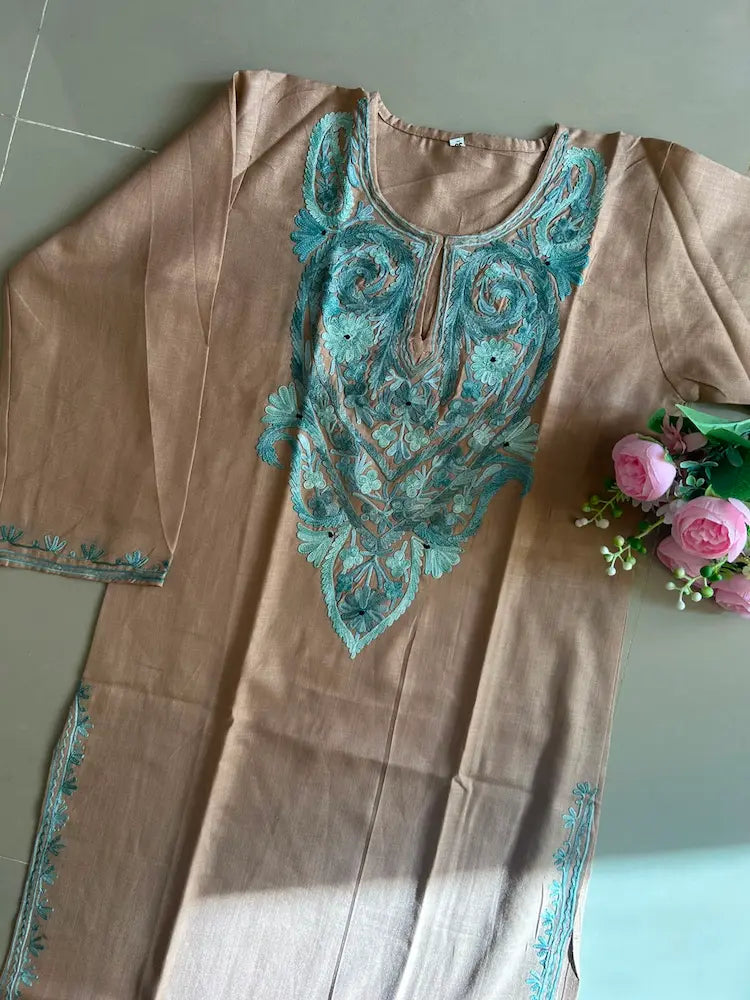 
Sehra sand brown cotton Kashmiri mid-length embroidered kurta featuring intricate traditional Kashmiri embroidery and soft breathable cotton fabric for elegant everyday ethnic wear by Hayat's Lucknowi.
