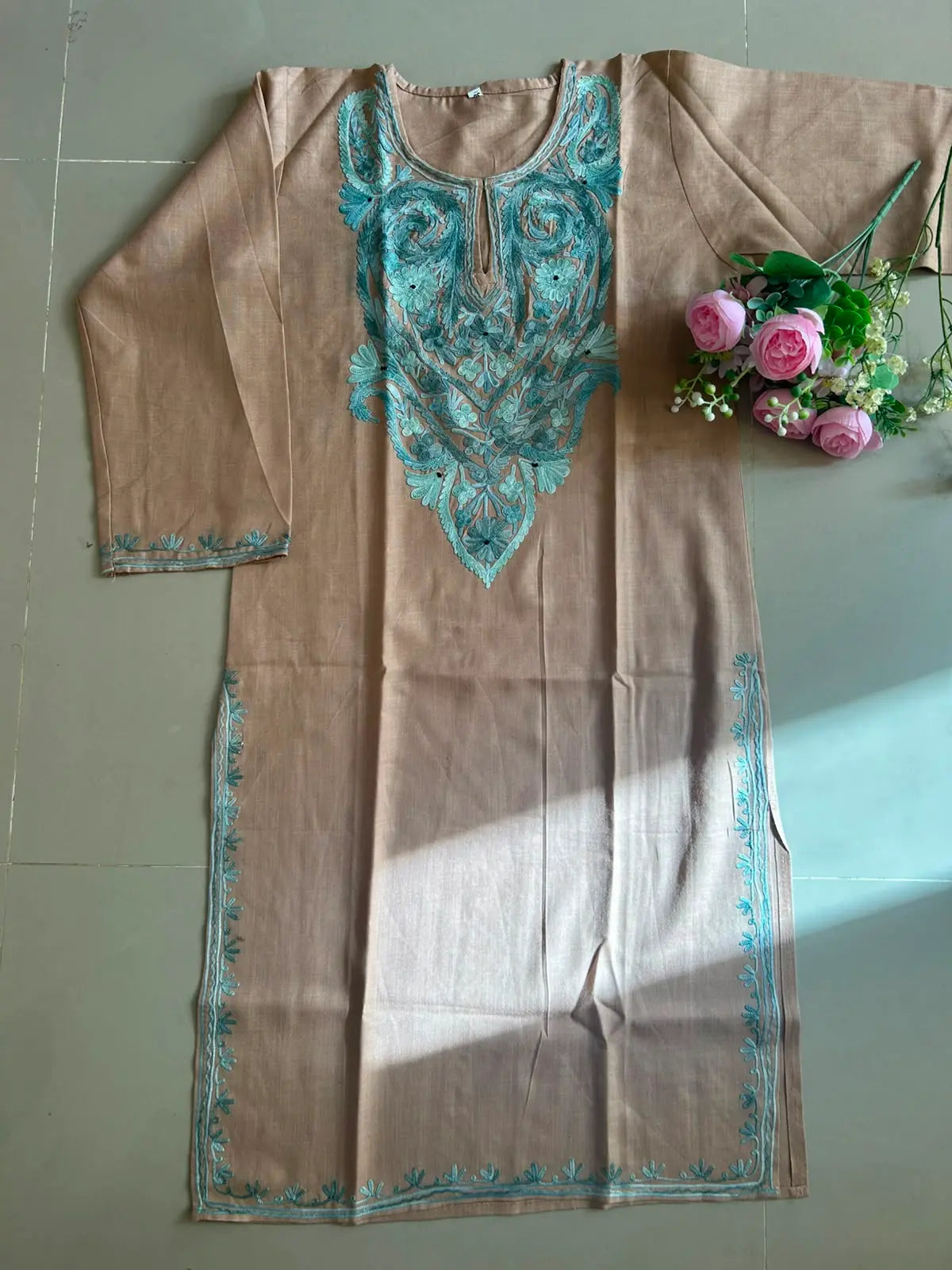 
Sehra sand brown cotton Kashmiri mid-length embroidered kurta featuring intricate traditional Kashmiri embroidery and soft breathable cotton fabric for elegant everyday ethnic wear by Hayat's Lucknowi.
