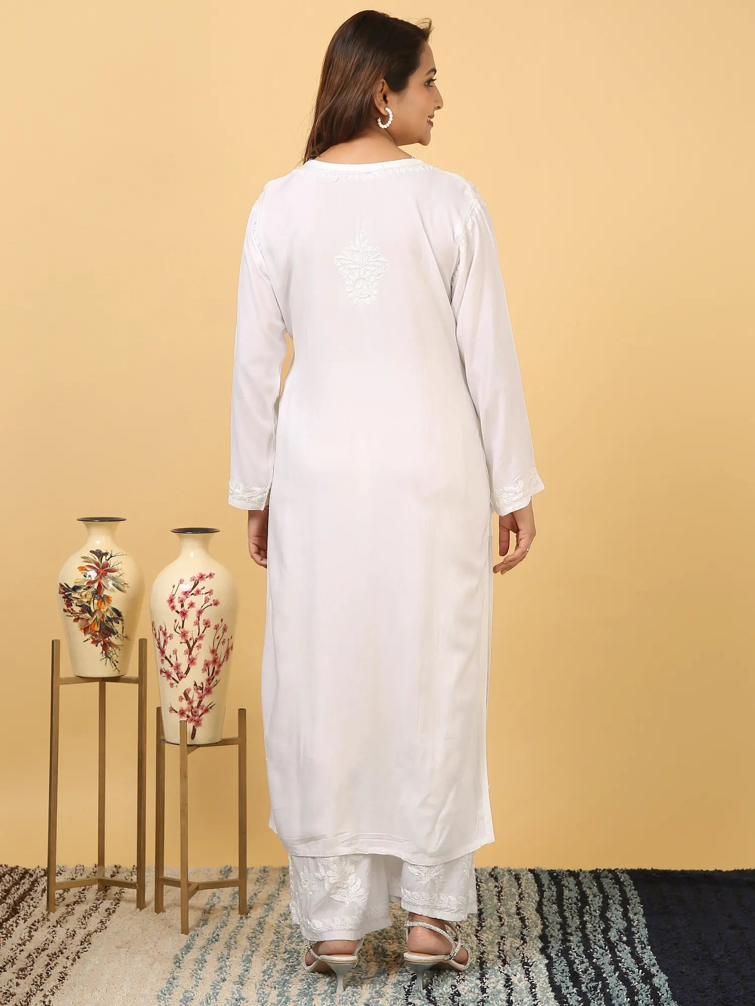 
White rayon Lucknowi chikankari kurta set with dupatta featuring delicate hand embroidery and elegant traditional craftsmanship for graceful festive and everyday ethnic wear by Hayat's Lucknowi.

