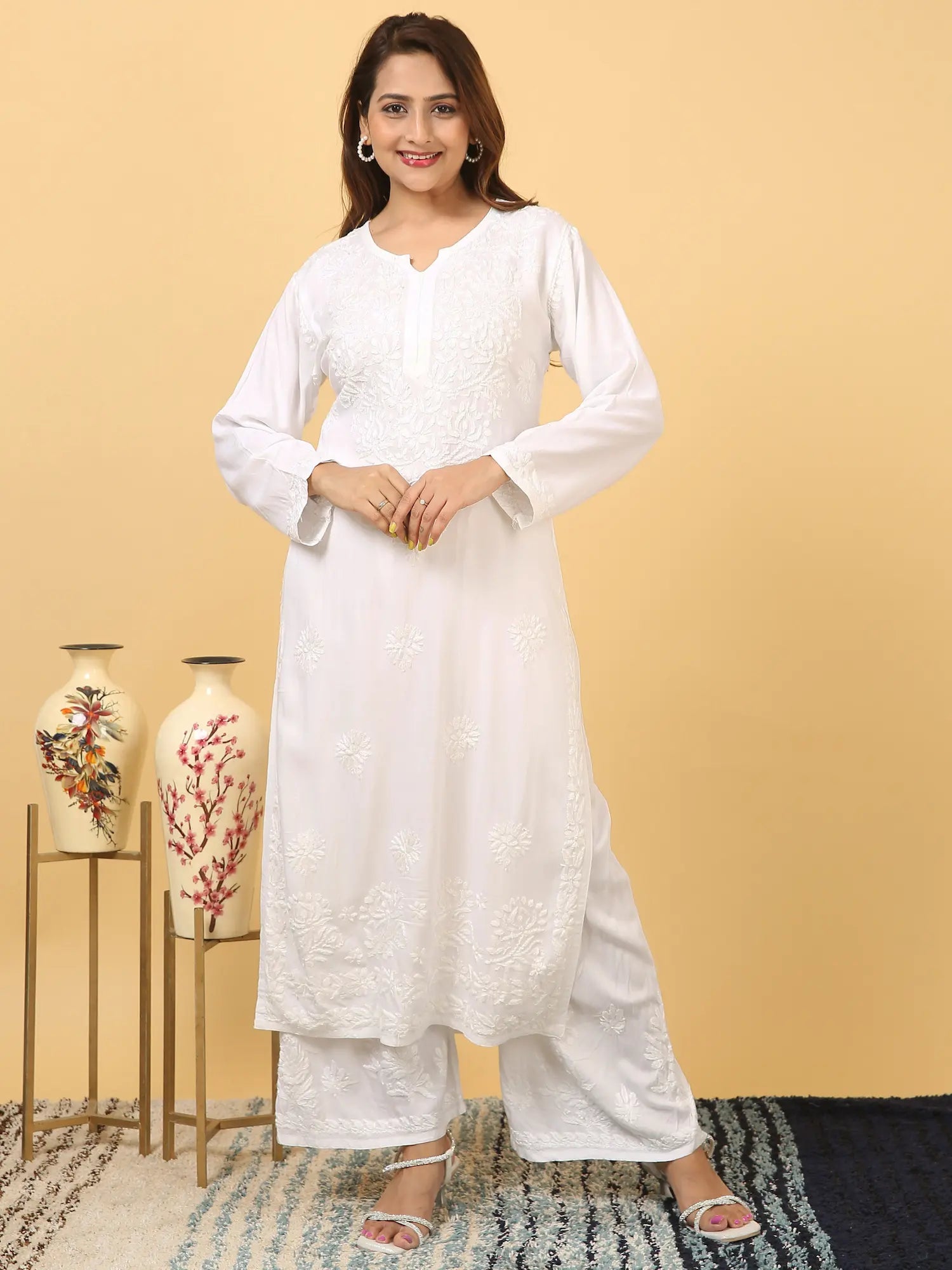 
White rayon Lucknowi chikankari kurta set with dupatta featuring delicate hand embroidery and elegant traditional craftsmanship for graceful festive and everyday ethnic wear by Hayat's Lucknowi.
