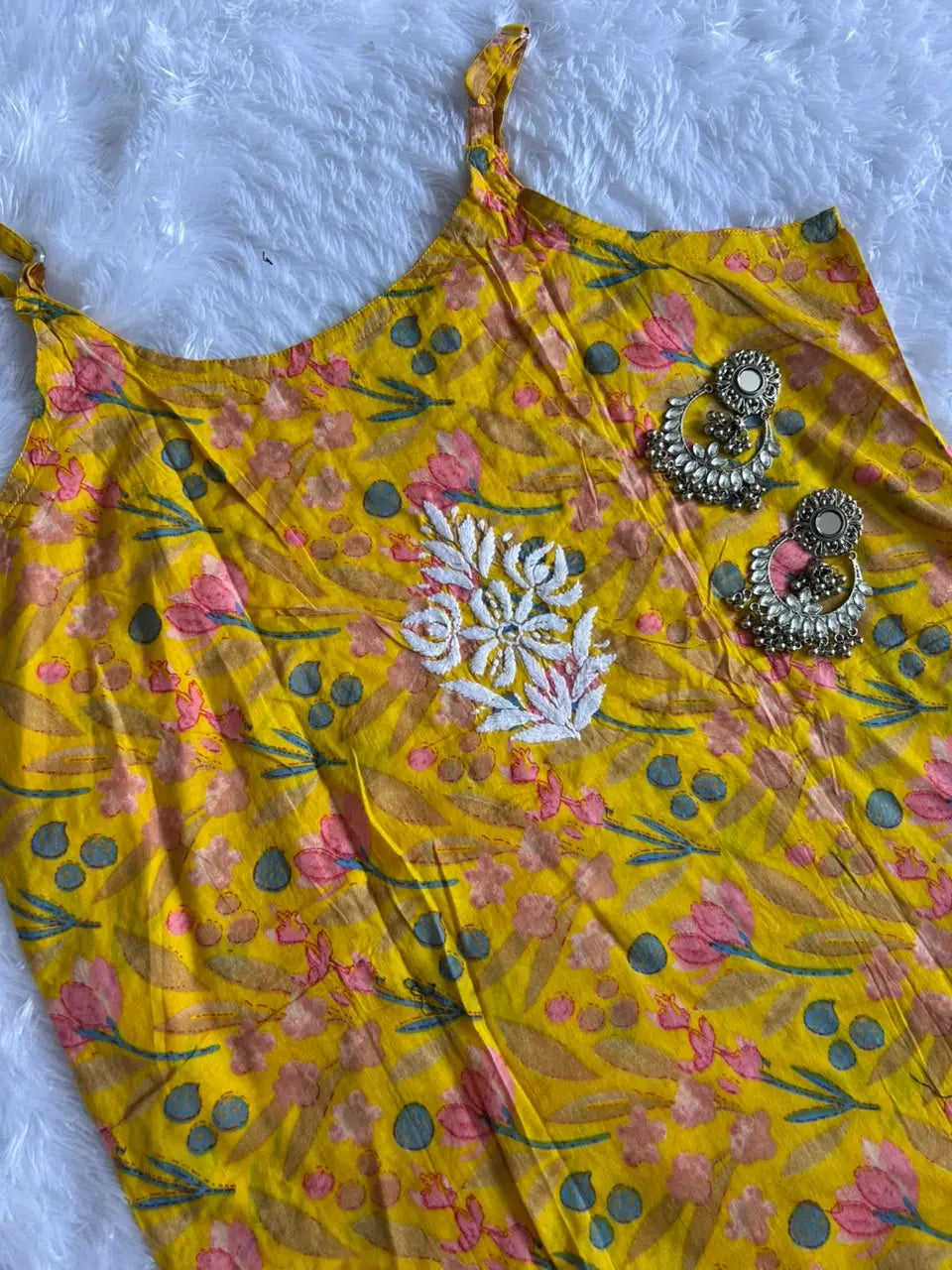Saaz Yellow Noodle Strap Mul Mul Kurta featuring delicate Chikankari embroidery on lightweight, soft and breathable Mul Mul cotton fabric for an elegant and effortless ethnic look by Hayat’s Lucknowi.
