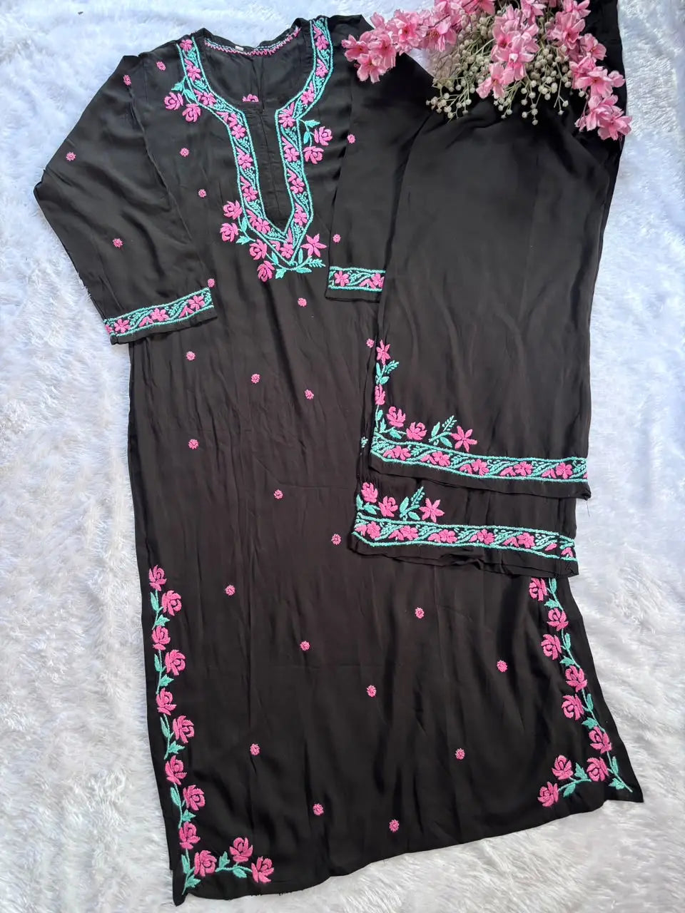 A black cotton kurta set with pink floral embroidery and green accents, chikankari lucknowi work